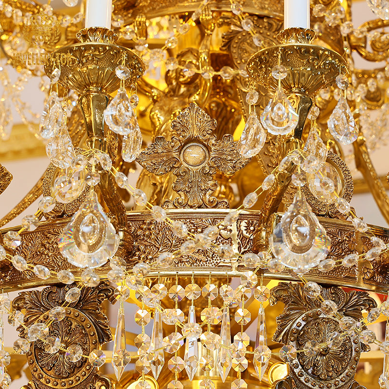 Extreme close-up of sparkling crystal facets and detailed brass craftsmanship on a chandelier.
