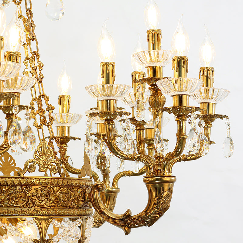Macro close-up of the finely detailed golden acanthus leaf carvings and the precision-cut crystal pendants.