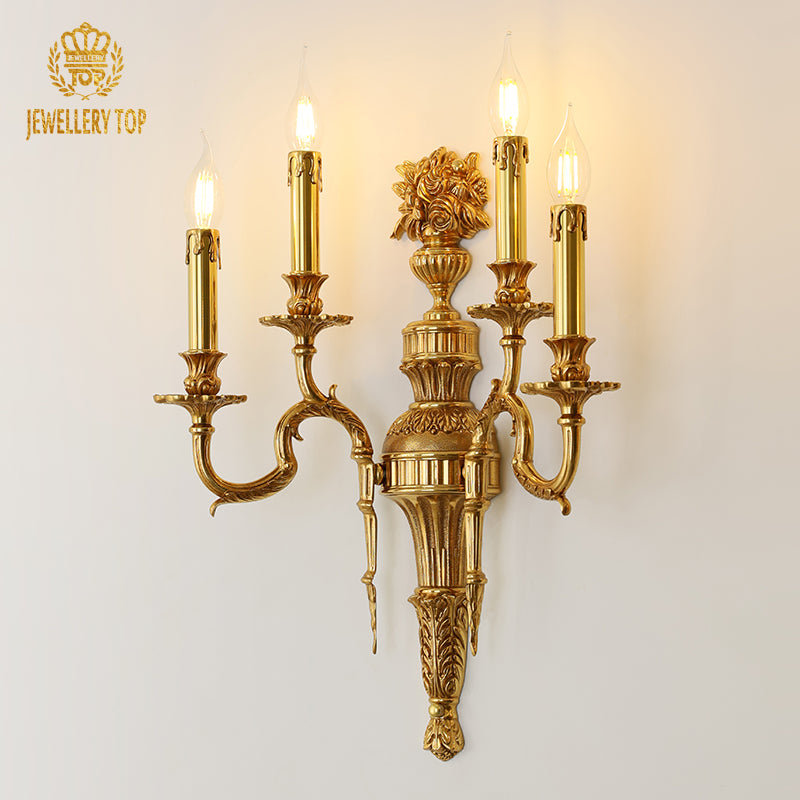 Detailed product close-up of the JEWELLERY TOP branded four-light brass corridor sconce with lit candle bulbs.