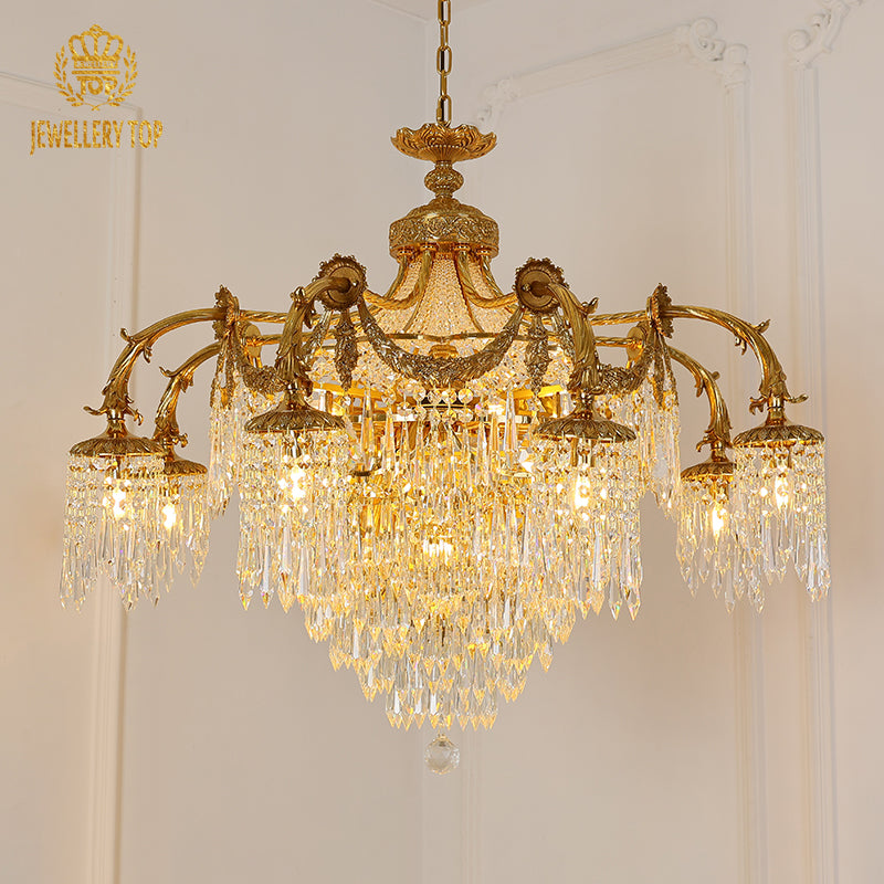 JEWELLERY TOP's European brass chandelier with a crystal cascade against a white wall.