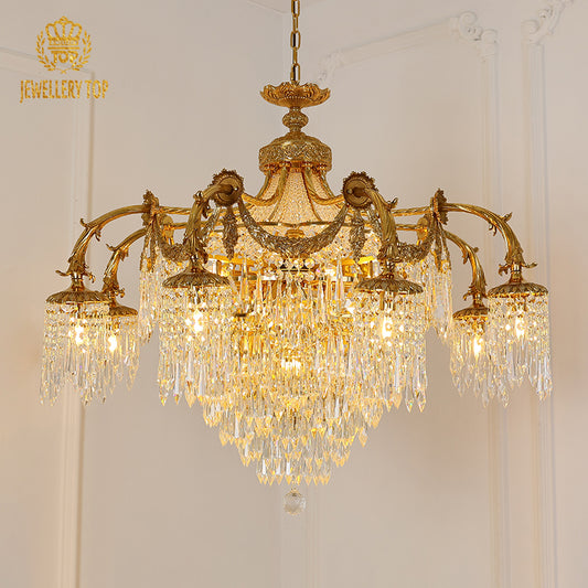 JEWELLERY TOP's European brass chandelier with a crystal cascade against a white wall.