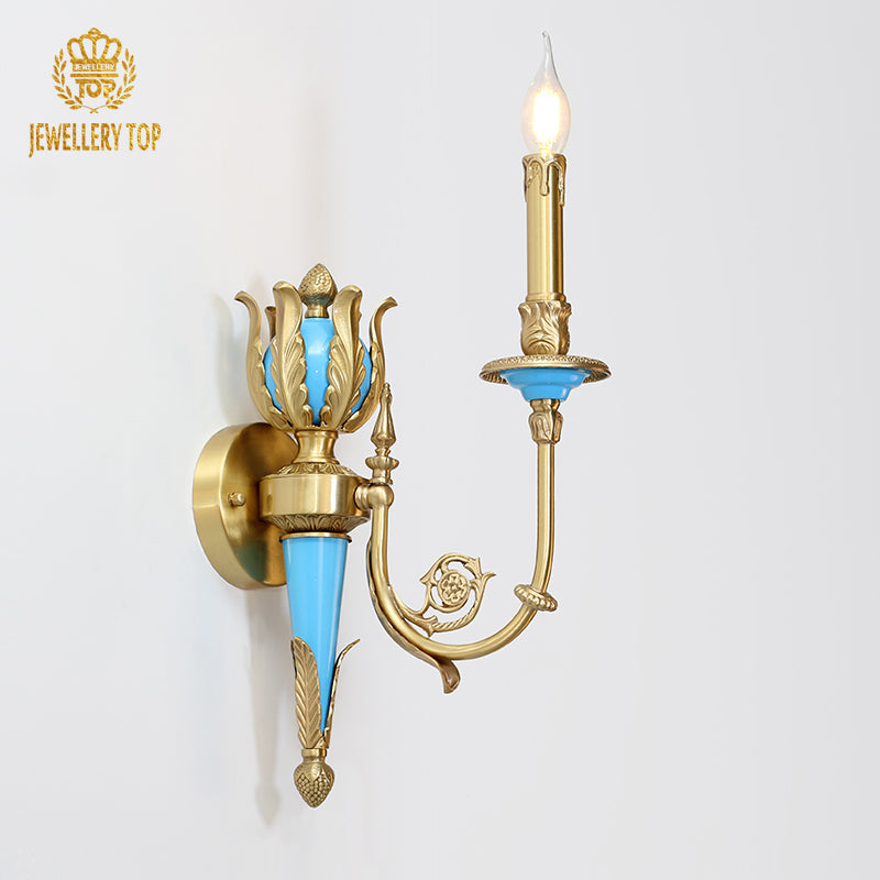 Detailed product shot of the golden and teal brass wall lamp with lit candle bulbs, brand JEWELLERY TOP.