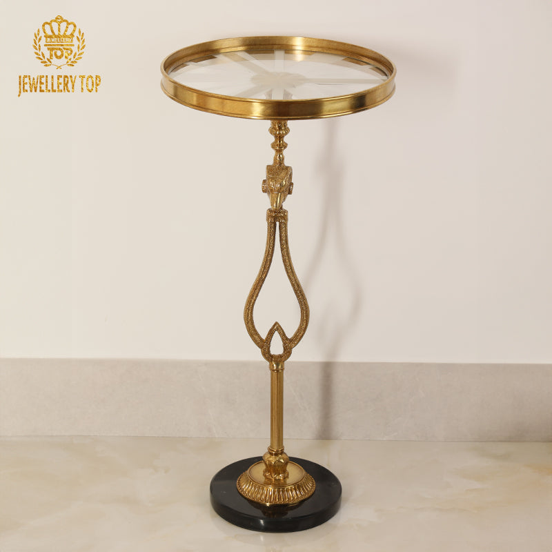 Angle view of The Chrysomallos brass accent table displaying the sunburst glass top by Jewellery Top.