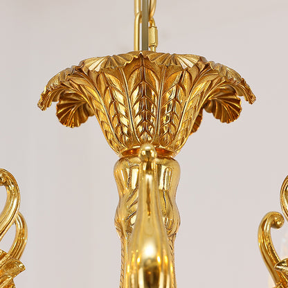 Macro close-up of a hand-carved brass rosette and a faceted crystal droplet.