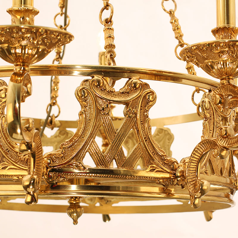 Extreme detail shot focusing on the teardrop crystal pendants and the finely cast golden acanthus leaves.
