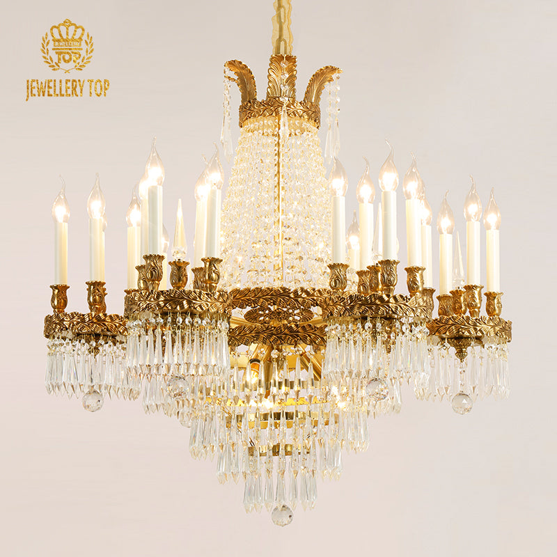 JEWELLERY TOP brand's golden brass chandelier with a crown-like top and crystal strands.