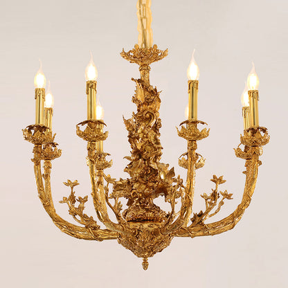 A lit decorative brass chandelier with curved arms and ceramic flower accents, isolated on white.