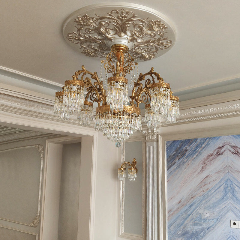 European brass chandelier installed in an interior with marble walls and classical moldings.