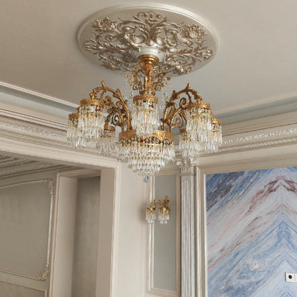European brass chandelier installed in an interior with marble walls and classical moldings.