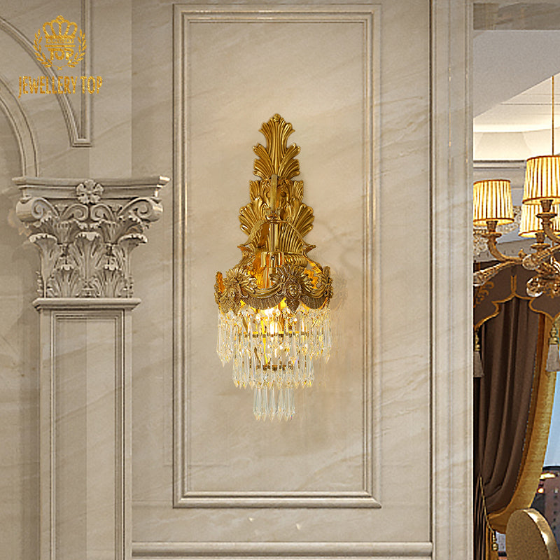The French hotel wall lamp installed on a white paneled wall, emitting a warm, luxurious glow in an elegant interior.