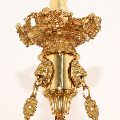 Macro close-up of the finely sculpted golden cherub figure holding a ring.
