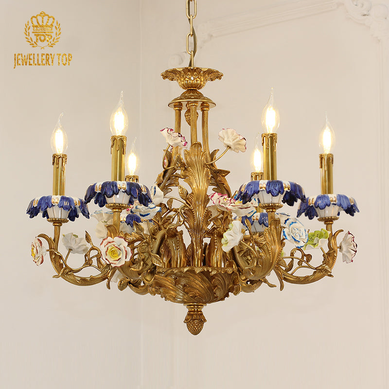 Front view of JEWELLERY TOP's brass chandelier with blue-and-white ceramic shades on a white wall.