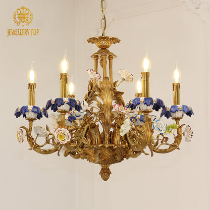 Front view of JEWELLERY TOP's brass chandelier with blue-and-white ceramic shades on a white wall.