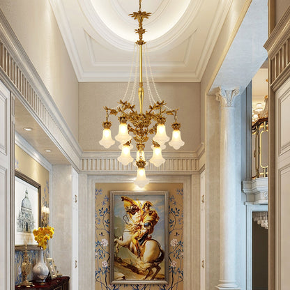 The French brass chandelier installed in a classic hallway with a dome ceiling and painting.