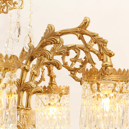 Extreme detail shot of ornate brass scrollwork and strings of crystal beads on a chandelier.