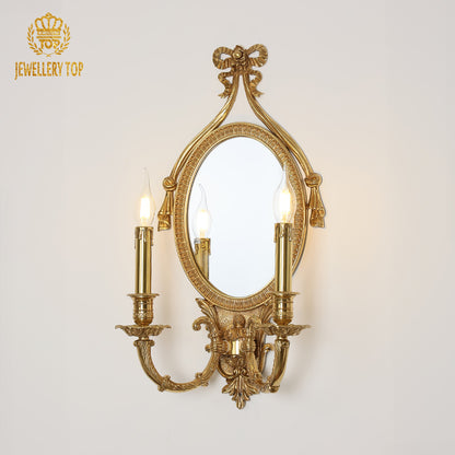 Close-up detail of the Venetian mirror wall light, highlighting the intricate brass scrollwork and JEWELLERY TOP logo.