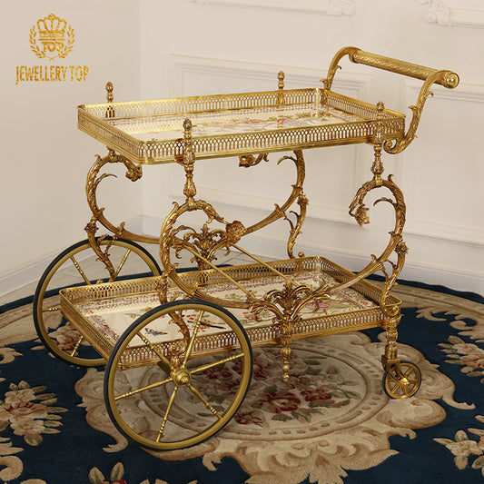 Full studio view of The Dionysus French Rococo solid brass bar cart with painted botanical ceramic trays by Jewellery T