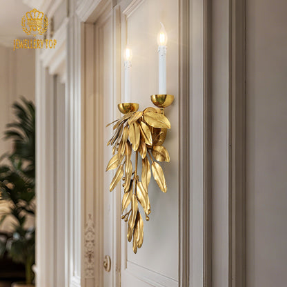 Detailed close-up of the French-style leaf wall light mounted on a white wall beside an ornate wooden door frame.