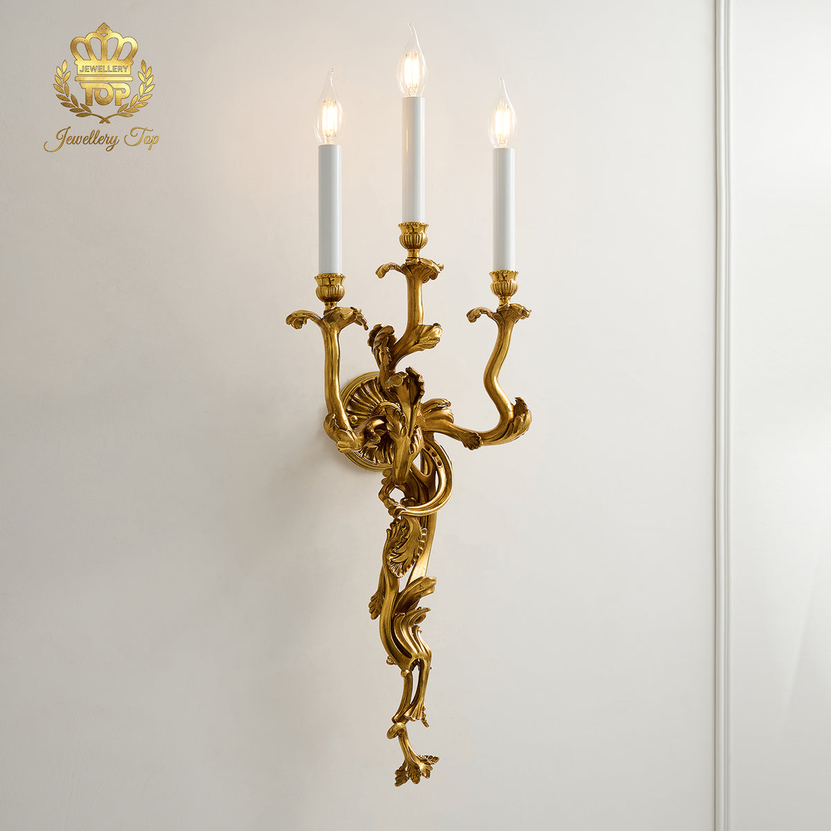 Side angle showing the flowing acanthus leaf branches of the brass Chloris wall sconce by Jewellery Top.