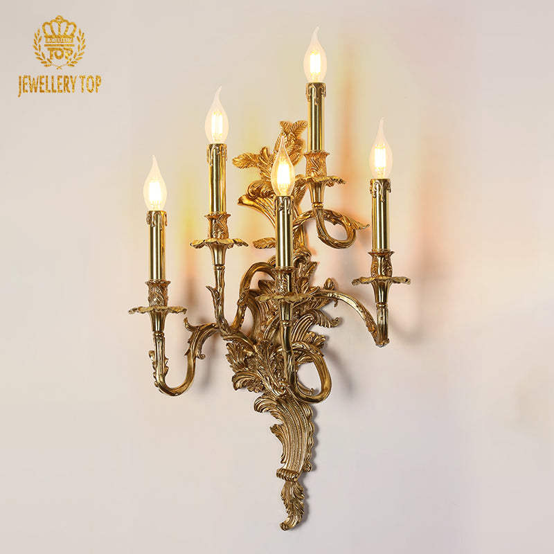 JEWELLERY TOP branded product shot of the ornate wall sconce, highlighting its five candle arms and golden finish.