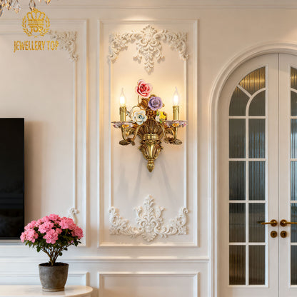 The installed ceramic flowers wall light in an elegant interior with a white cabinet, pink peonies, and decorative moldings.