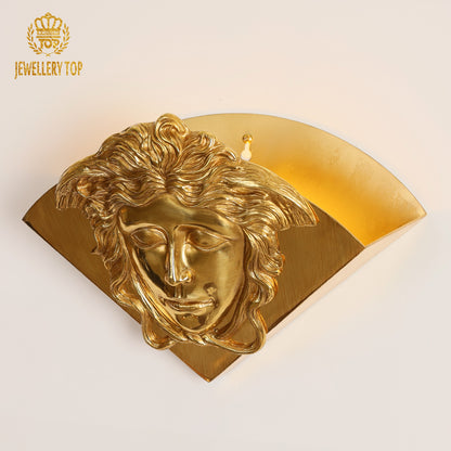 Front product view of a JEWELLERY TOP designer wall sconce featuring an ornate human head sculpture.