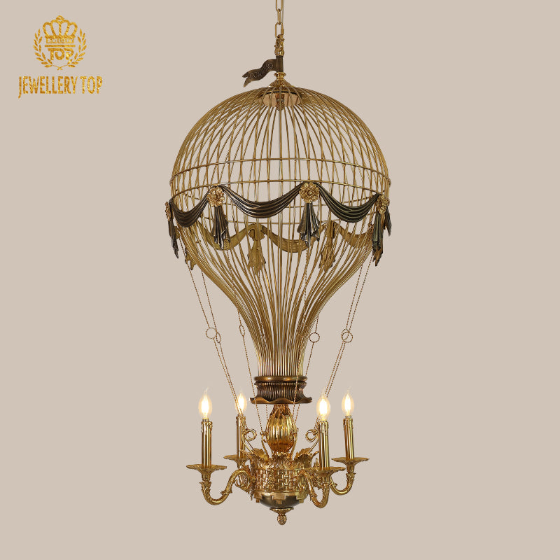 Side view of JEWELLERY TOP's hot-air balloon brass chandelier with fabric drapes and flowers.