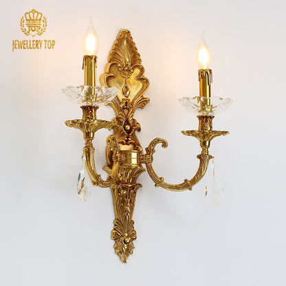 JEWELLERY TOP branded product close-up of the ornate golden sconce with lit bulbs and intricate metalwork.