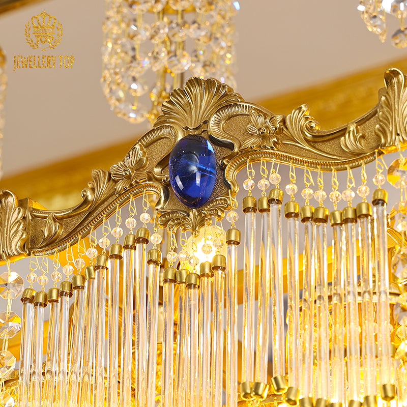 Extreme detail shot focusing on the sparkling teardrop crystal pendants and the polished brass canopy at the ceiling mount.