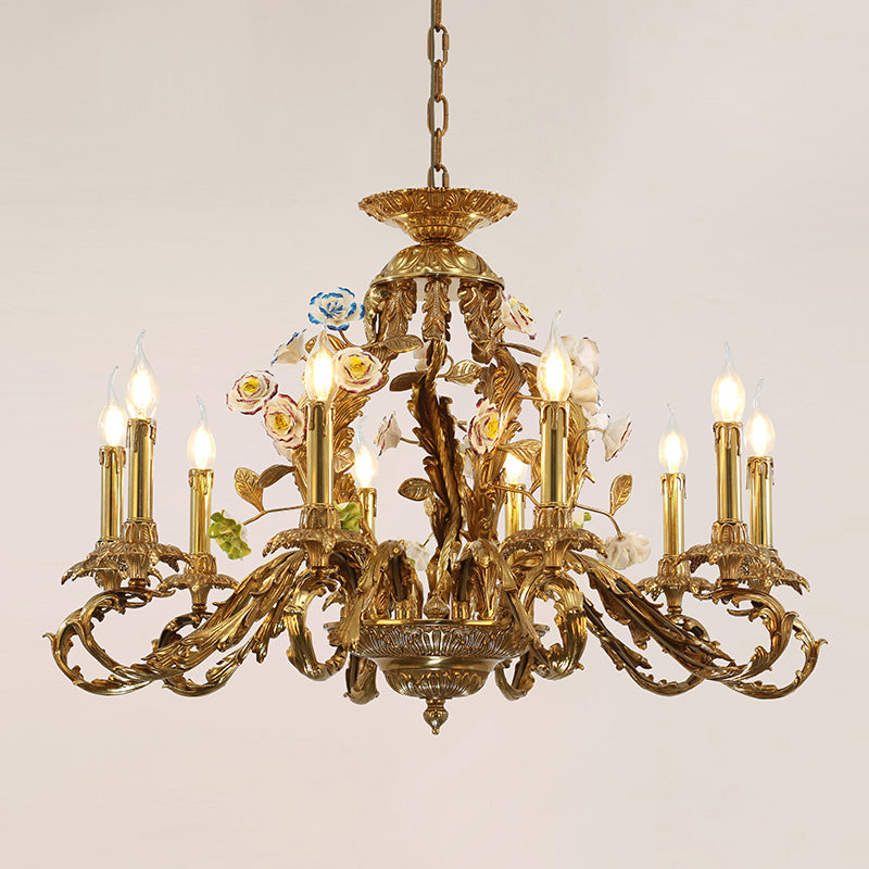 Detailed perspective of a golden brass chandelier adorned with pink, white, and blue ceramic blooms.