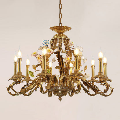 Detailed perspective of a golden brass chandelier adorned with pink, white, and blue ceramic blooms.