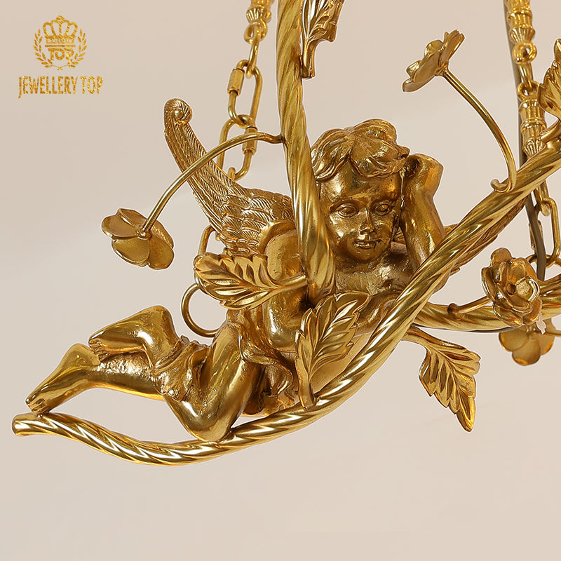 Macro close-up of the finely detailed cherub's face, wings, and the textured brass oak leaves.
