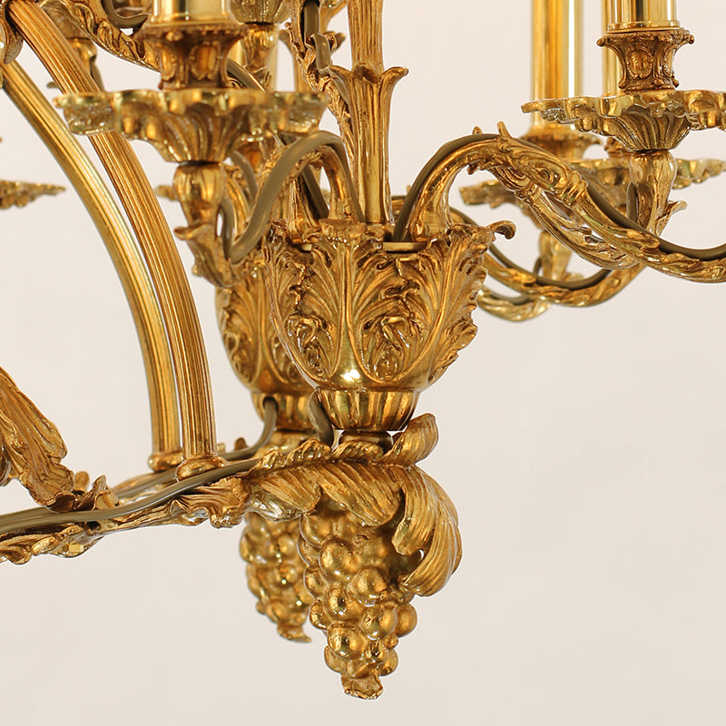 Detailed shot of exquisite grape cluster and leaf on a golden Baroque brass chandelier arm.