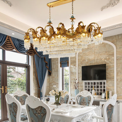 A luxury dining room chandelier illuminating an elegant space with large windows and classic drapery.
