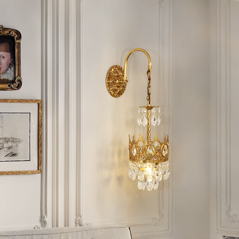 The brass sconce mounted as a pair beside a mirror, demonstrating its perfect scale for bedroom or vanity use.