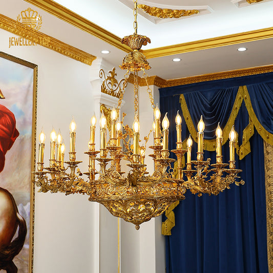 A victorian chandelier installed in a grand residence hallway with ornate wall moldings and a sweeping staircase.