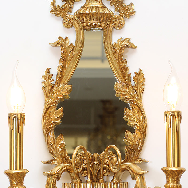 The vanity wall light in a classic interior setting, providing elegant illumination beside a decorative vase.