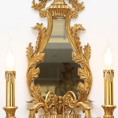 The vanity wall light in a classic interior setting, providing elegant illumination beside a decorative vase.