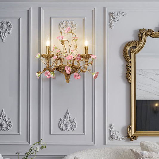 The installed European luxury brass wall lamp on a light gray paneled wall next to a gold-framed mirror.