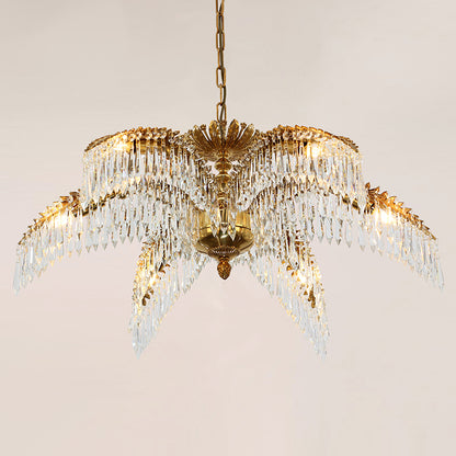 The crystal-adorned brass chandelier casting sparkling light patterns on a neutral wall.