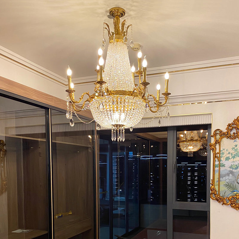 Installed Rococo brass chandelier in an elegant interior with wooden cabinets and artwork.