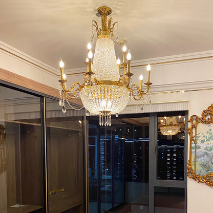Installed Rococo brass chandelier in an elegant interior with wooden cabinets and artwork.