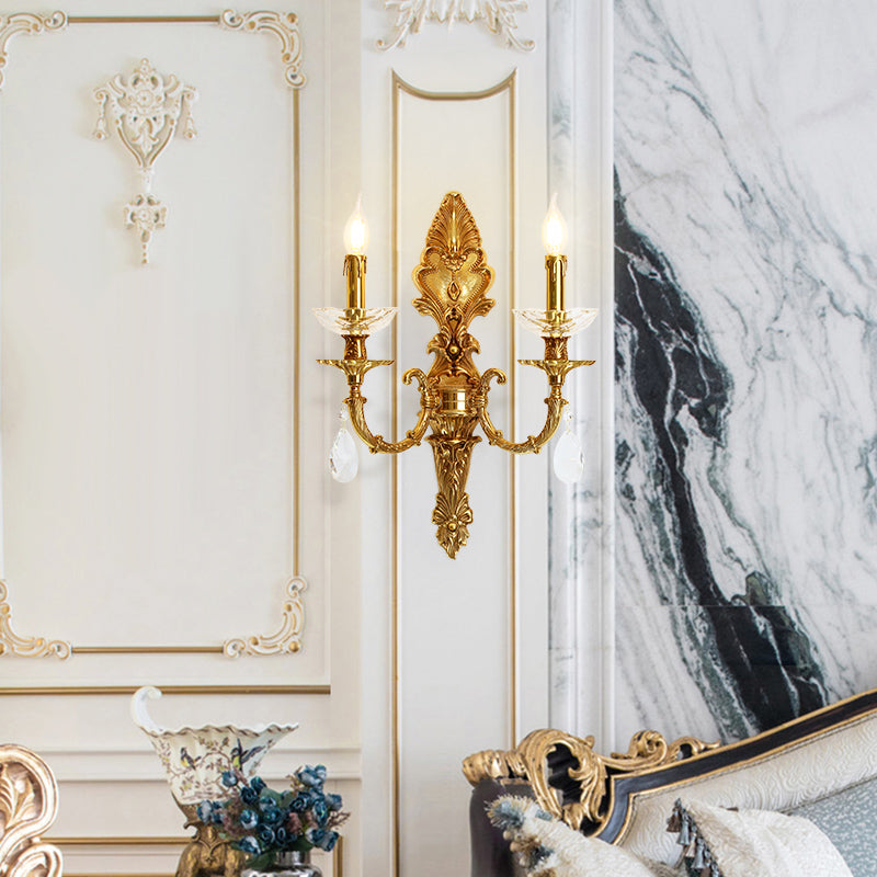 The French wall light installed on white wainscoting beside a marble fireplace and blue floral vase.