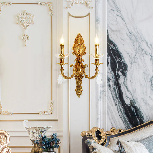 The French wall light installed on white wainscoting beside a marble fireplace and blue floral vase.