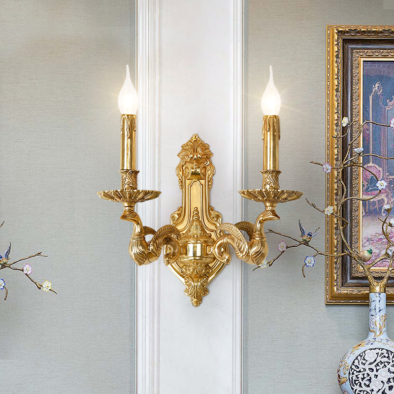 The French antique wall light installed on a light-colored wall beside classical artwork and a decorative vase.