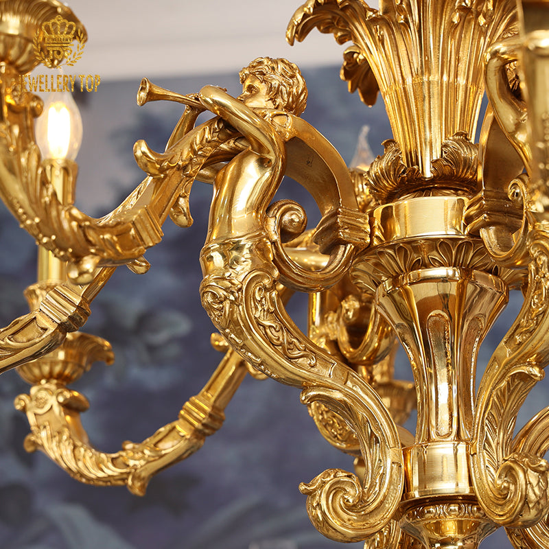 Macro shot of a cherub playing a flute amidst ornate brass scrollwork on the chandelier.