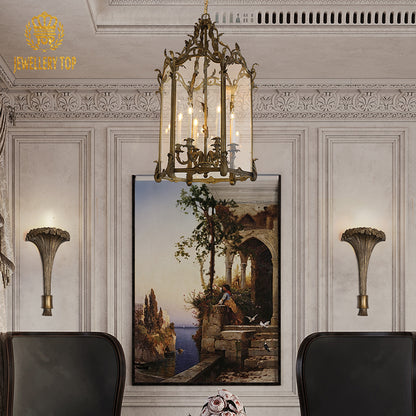 JEWELLERY TOP antique bronze pendant light above a coastal painting in an elegant interior.
