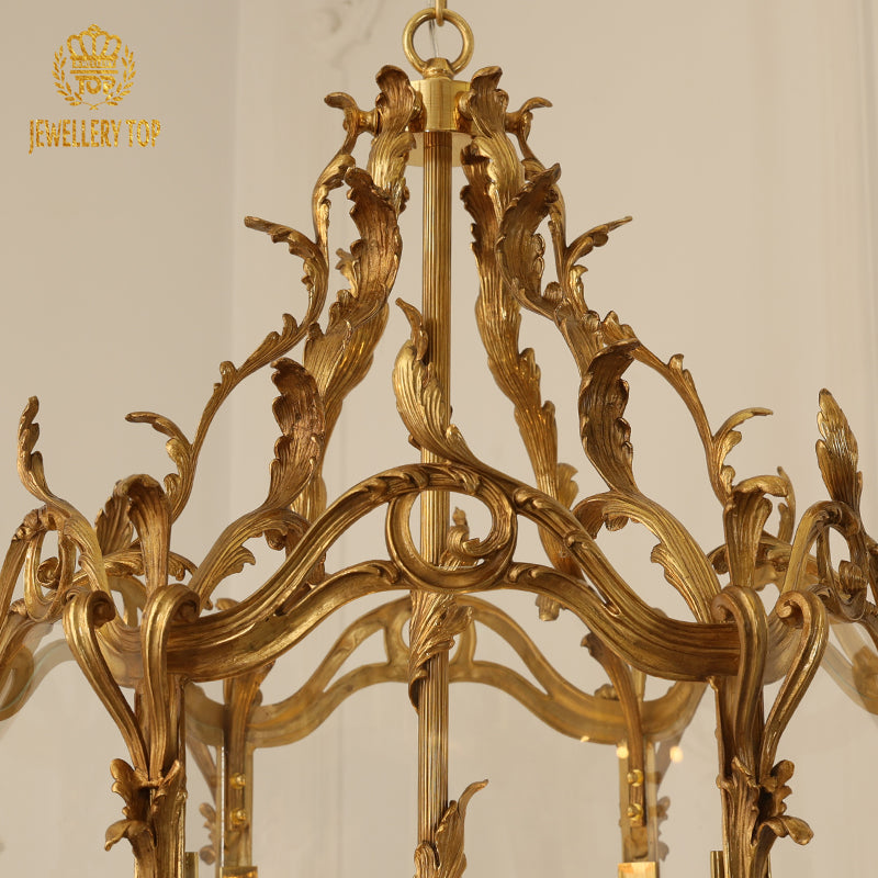 Close-up detail of the ornate brass column and canopy of a luxury decorative pendant light.