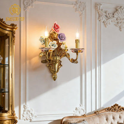 Side view of the brass wall lamp highlighting its intricate metal scrollwork and the warm glow from its bulbs.
