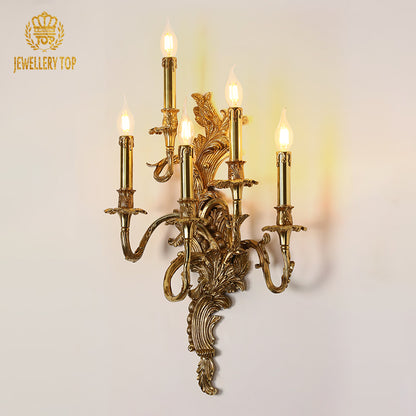 Macro detail of the sconce’s central ornate medallion and the finely crafted candle holder with bulb.